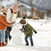 happy family mother and children daughter and son having fun on winter walk