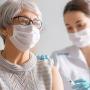 Doctor giving a senior woman a vaccination. Virus protection. COVID-2019.; Shutterstock ID 1868898253; ENTER PO 4700007205: GSK