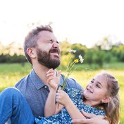 Father with a small daughter having fun in sunny spring nature.