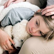 Shot of a sad sick boy keeping his head on his mother's lap